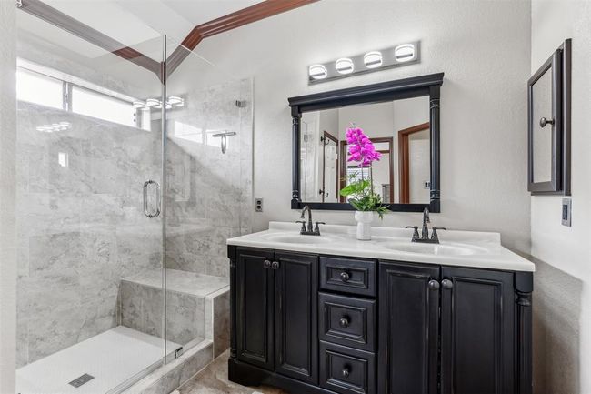 Full bath with double vanity, a stall shower, and a sink | Image 5
