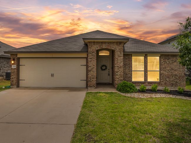 View of front of home with brick siding, concrete driveway, a garage, a yard, and a shingled roof | Image 24
