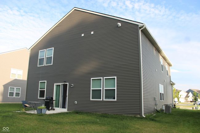 back of property featuring a lawn and a patio area | Image 7
