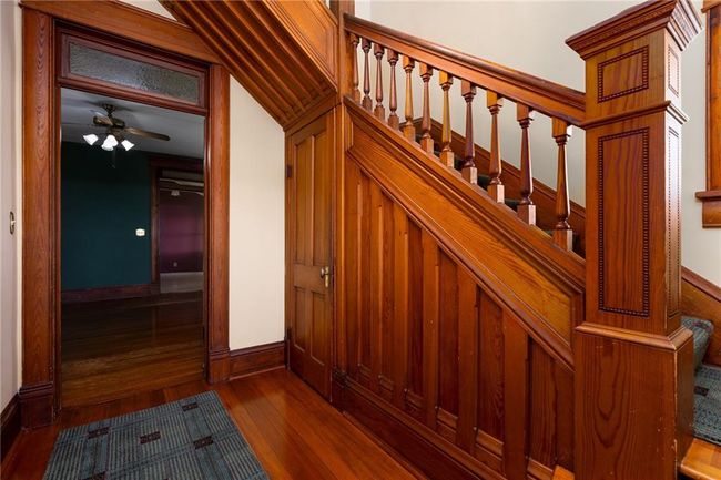 Staircase with ceiling fan and dark hardwood / wood-style floors | Image 6