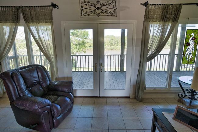 Windows all across, French doors to the Deck | Image 15