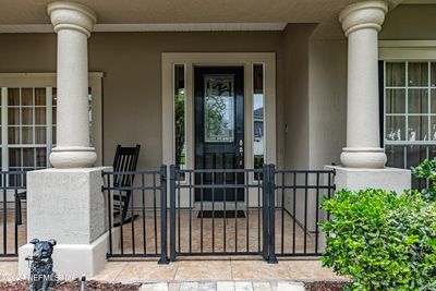 COVERED FRONT PORCH WITH DOGGIE FENCE/GATE | Image 2