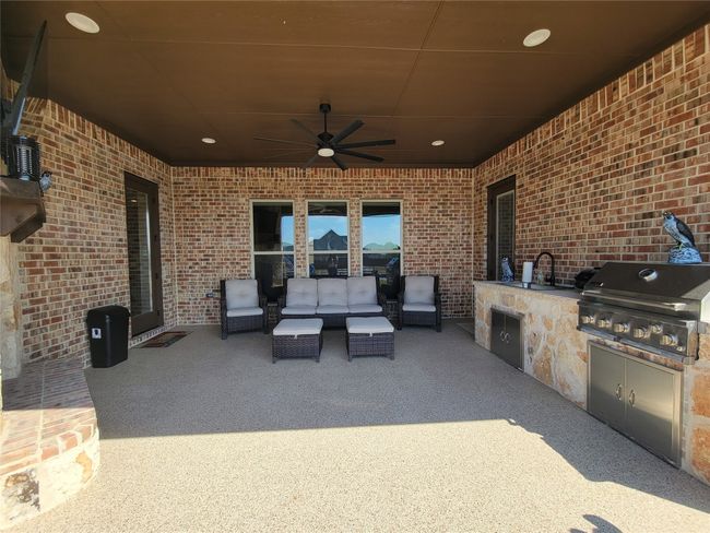 View of patio featuring exterior kitchen, a ceiling fan, and an outdoor living space | Image 7
