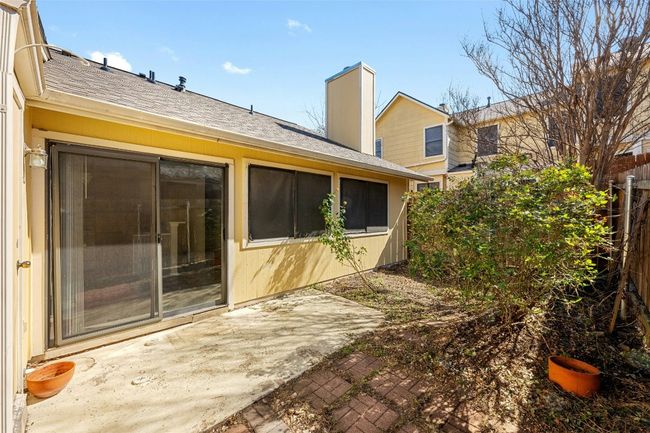 Back of house featuring a patio area, a shingled roof, a chimney, and fence | Image 17