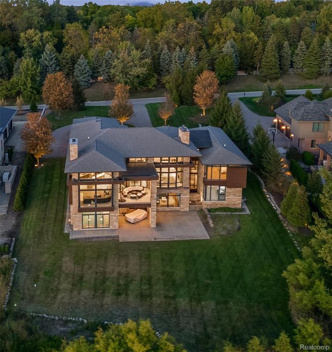 Back of house featuring a patio area, a yard, and stone siding | Image 38
