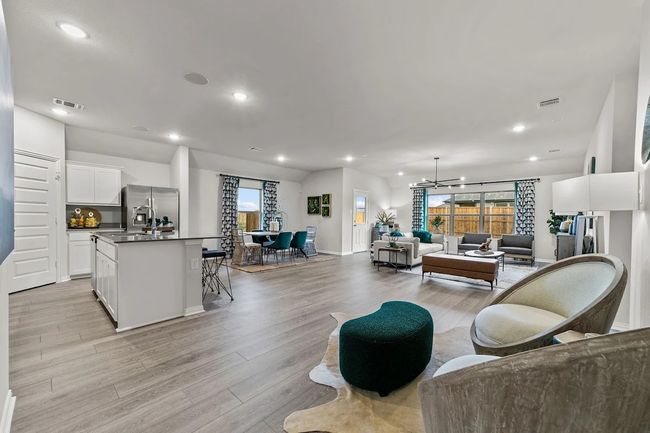 Living room featuring light wood finished floors, a chandelier, recessed lighting, and baseboards | Image 20