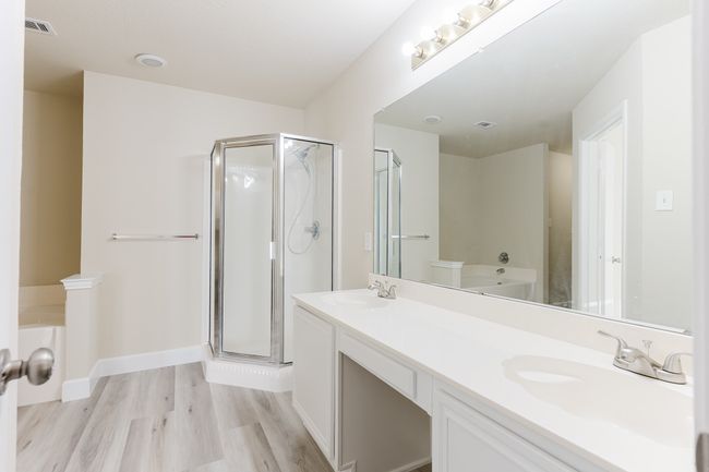 Full bath with a stall shower, visible vents, a sink, and wood finished floors | Image 12