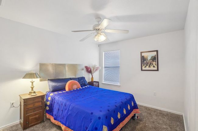 Bedroom with baseboards, a ceiling fan, and carpet | Image 24
