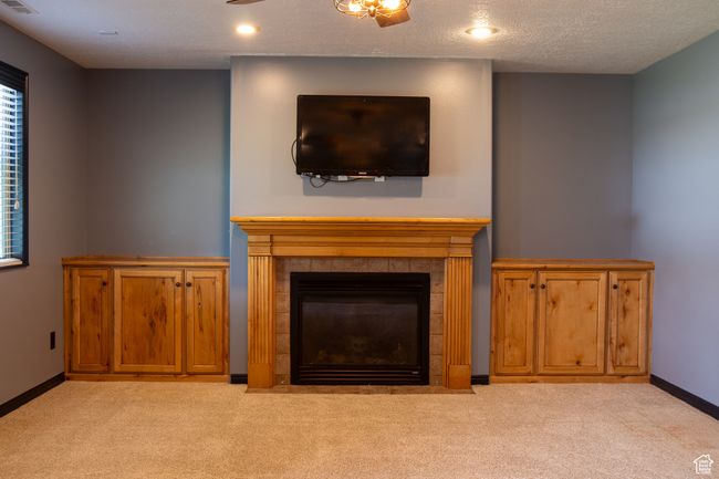 Detailed view of carpet, a gas fireplace, baseboards, and recessed lighting | Image 10