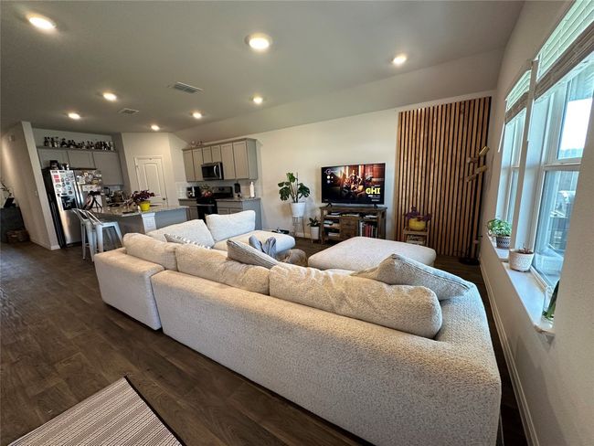Living area featuring dark Vinyl finished floors and recessed lighting | Image 5