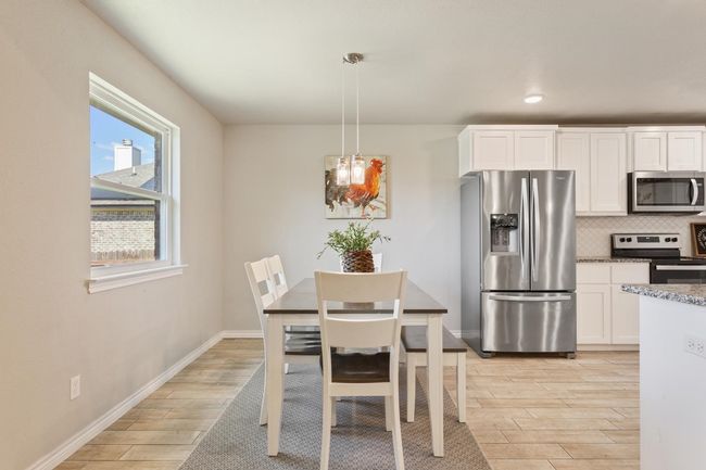 Dining area featuring light wood finished floors and recessed lighting | Image 12