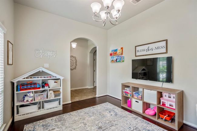 From the bright flex space, enjoy a clear view back through the arched opening to the foyer, connecting your home’s entry with versatile living areas. | Image 6