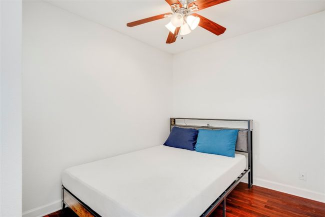 Bedroom featuring baseboards, wood finished floors, and ceiling fan | Image 34