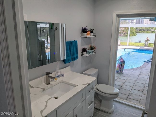 Bathroom featuring vanity, a water view, toilet, and a shower stall | Image 34