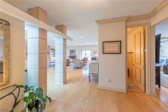 Main entry foyer with ornate columns, recessed lighting, light wood flooring, and high ceilings. | Image 22
