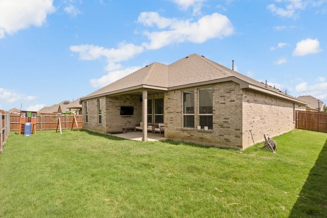 Back of house featuring brick siding, a fenced backyard, a patio, and roof with shingles | Image 21