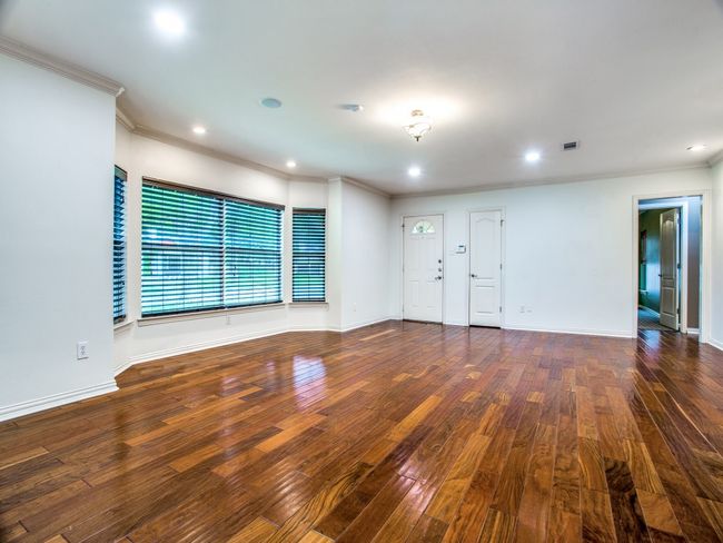 Unfurnished living room featuring recessed lighting, baseboards, wood-type flooring, and ornamental molding | Image 4