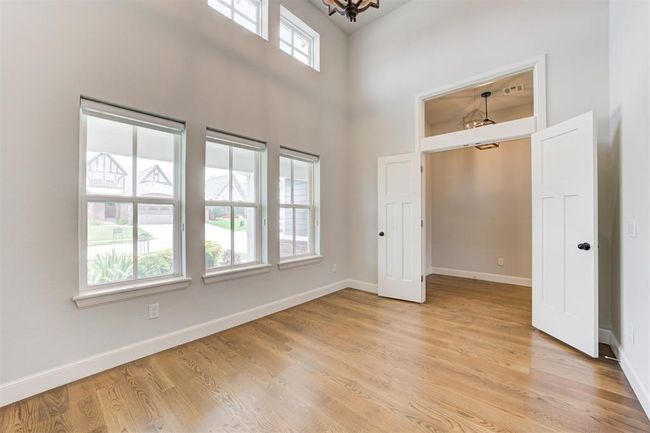 Large study with soaring ceilings and a wall of windows. | Image 26
