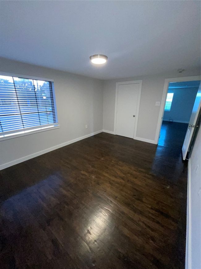 Spare room with dark wood finished floors and baseboards | Image 10
