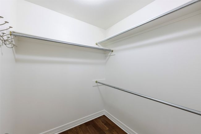 Spacious closet with dark wood-style floors | Image 10