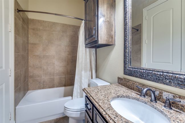 Full bath featuring toilet, vanity, and shower / bathtub combination with curtain | Image 29