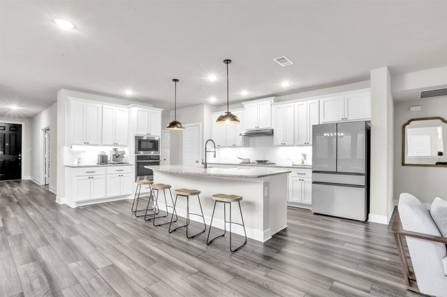 Dining area featuring light wood finished floors, stairway, and baseboards | Image 6