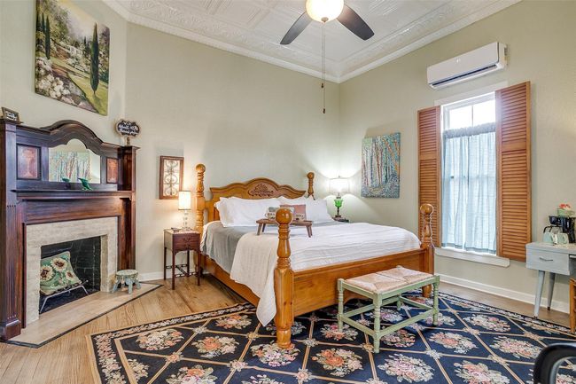 Kason's Cove features a pillow top King bed, fireplace, hardwood floors, privatte bathroom with mosaic floor and subway tile, decorated with estate sale finds and eclectic art | Image 35