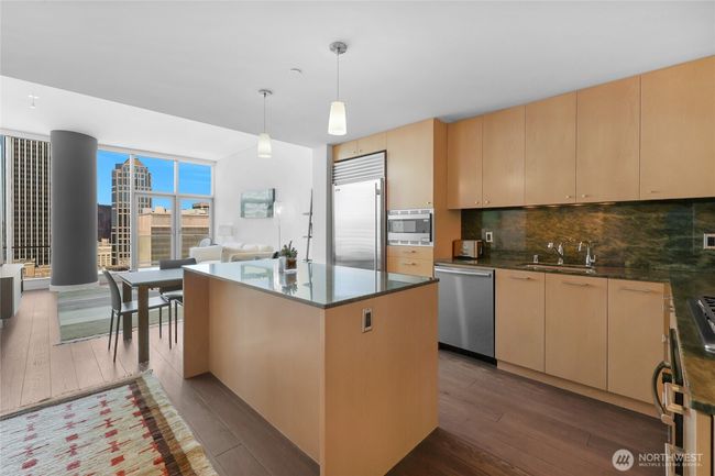 Modern kitchen with high end appliances including Subzero fridge. | Image 15