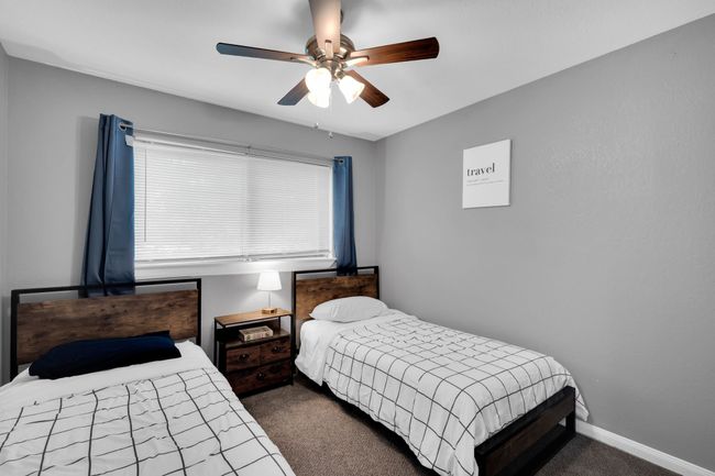 Bedroom featuring baseboards, dark colored carpet, and a ceiling fan | Image 21