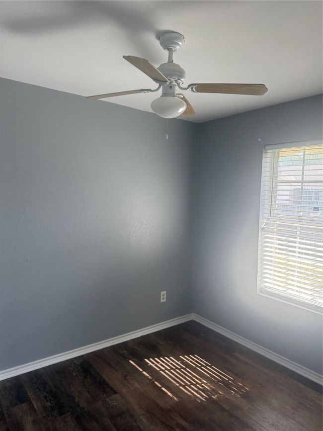 Empty room featuring a ceiling fan, wood finished floors, and baseboards | Image 10