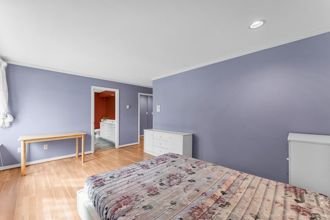 Bedroom with light wood-style flooring, baseboards, crown molding, and connected bathroom | Image 17