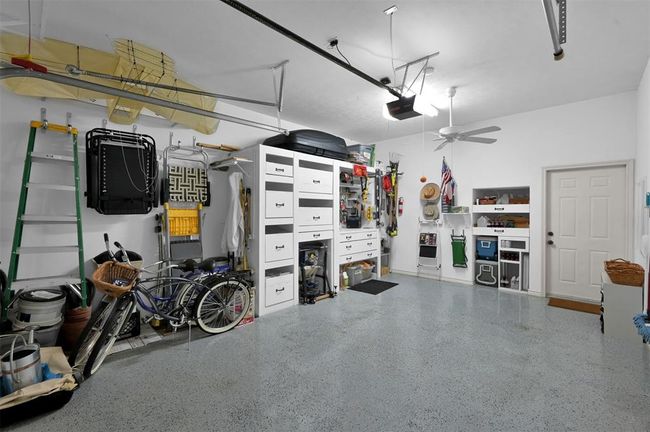 The garage is every handyman's dream with epoxy flooring, built-in work station with power tools included and loaded with storage. | Image 24