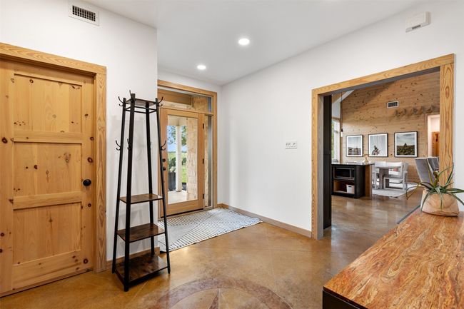 Foyer entrance with finished concrete flooring and recessed lighting | Image 11