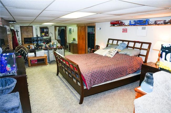 Carpeted bedroom featuring a drop ceiling | Image 18