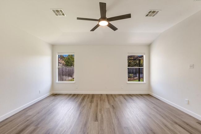 You'll love the large primary bedroom. Fresh luxury vinyl flooring, updated ceiling fan and great natural light. | Image 6