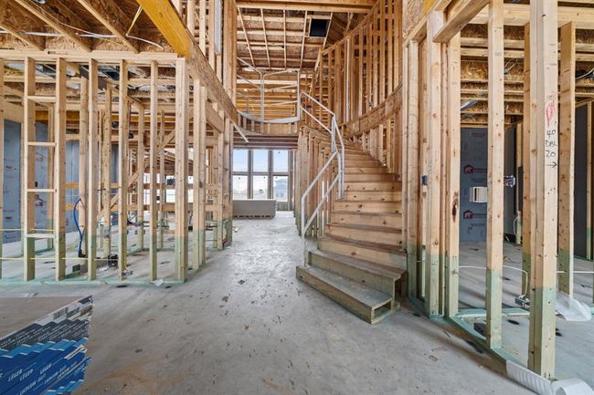 Elegant entryway with a curved staircase as the focal point. | Image 8
