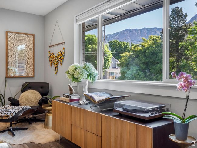 Office space featuring a mountain view and wood finished floors | Image 11