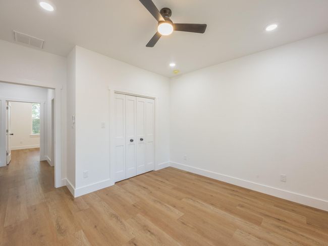Generously sized with neutral tones and ample closet space, this secondary bedroom is perfect for guests, kids, or a home office setup. | Image 32