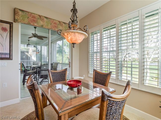 Dining room featuring ceiling fan and light tile floors | Image 9