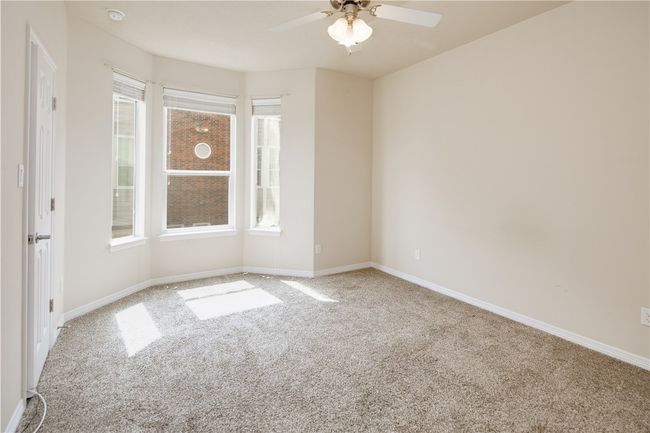 Unfurnished room with baseboards, a ceiling fan, and carpet flooring | Image 8