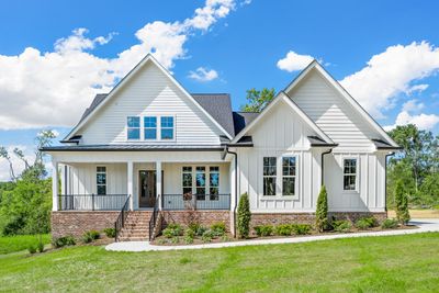 We love the front elevation of this home! The brick and creamy white details of the exterior give this a classic clean modern farmhouse look. Craftsworth Builders really knocked this one out of the park! | Image 1