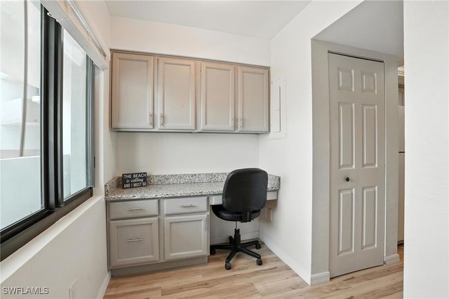 Office with built in desk and light wood-type flooring | Image 18