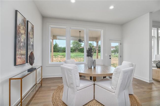 Dining area featuring wood-type flooring and a healthy amount of sunlight | Image 16