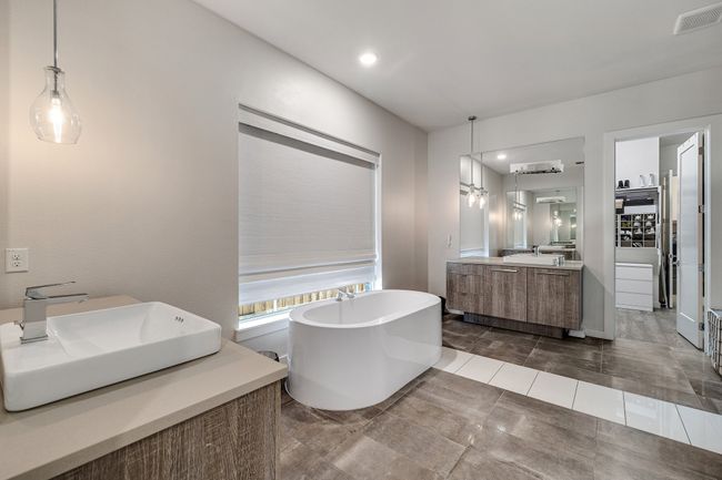 Bathroom featuring vanity, a freestanding tub, tile patterned floors, and recessed lighting | Image 23