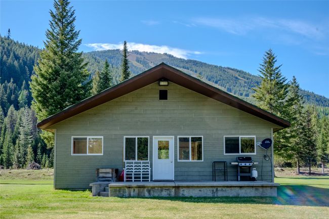 Back of property with a yard, a wooded view, and a mountain view | Image 76