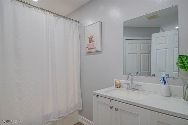 Bathroom featuring vanity and a shower with curtain | Image 11