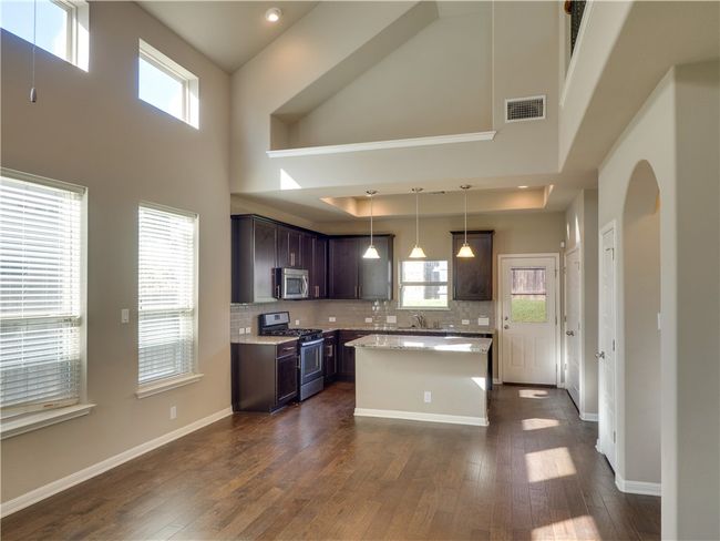 Living Area with wooden flooring and vaulted ceiling | Image 6