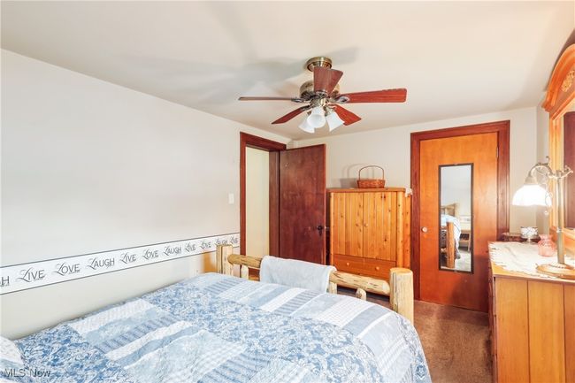 Carpeted bedroom with ceiling fan | Image 18