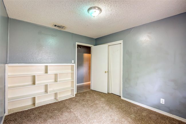 Unfurnished bedroom with carpet, a textured ceiling, a closet, and baseboards | Image 21