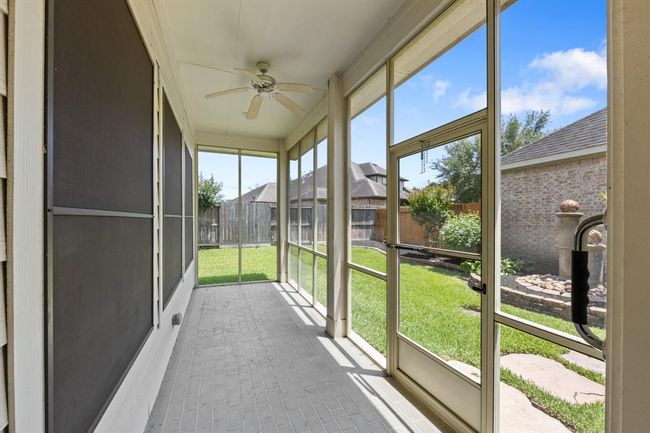 The enclosed covered patio provides a perfect place for relaxing or entertaining year-round with added privacy and protection from the elements. | Image 41